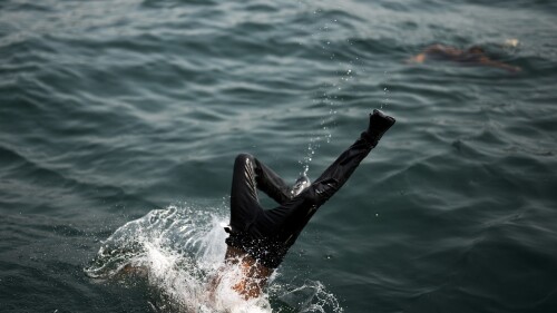 A youngster dives into the Bosphorus at Karakoy sea promenade on a hot summer day in Istanbul, Turkey, Friday, July 14, 2023. (AP Photo/Francisco Seco)