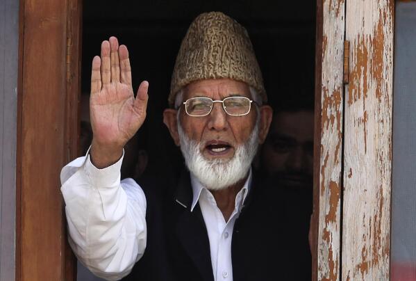 CORRECTS AGE - FILE - In this Wednesday, Sept. 8, 2010, file photo, Kashmiri separatist leader Syed Ali Shah Geelani waves to the media before his arrest in Srinagar, India. Geelani, an icon of disputed Kashmir’s resistance against Indian rule and a top separatist leader who became the emblem of the region’s defiance against New Delhi, died late Wednesday, Sept, 1, 2021. He was 91. (AP Photo/Altaf Qadri, File)