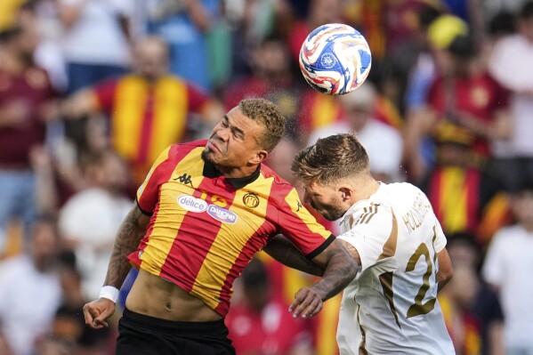 Esperance de Tunis' Yan Sasse, left, and Los Angeles FC's Ryan Hollingshead battle for the ball during the Club World Cup Group D soccer match between Los Angeles FC and ES Tunisie in Nashville, Tenn., Friday, June 20, 2025. (AP Photo/George Walker IV)