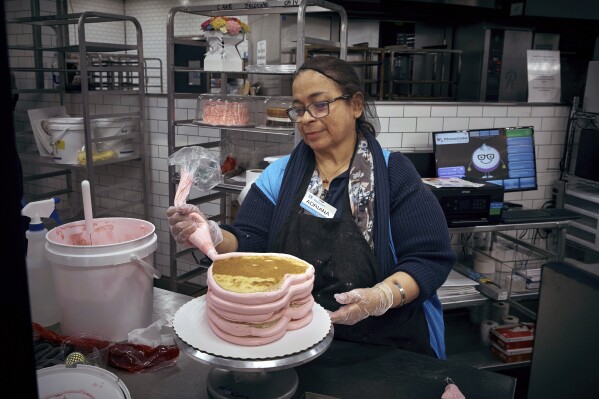 An employee makes a cake inside Walmart Supercenter on Wednesday, May 28, 2025, in North Bergen, N.J. (AP Photo/Andres Kudacki)