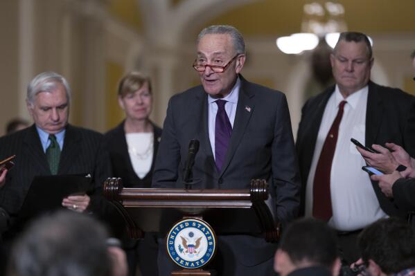 Senate Majority Leader Chuck Schumer, D-N.Y., joined from left by Sen. Jack Reed, D-R.I., chairman of the Senate Armed Services Committee, Sen. Tammy Baldwin, D-Wis., and Sen. Jon Tester, D-Mont., speaks to reporters before a vote on legislation to protect same-sex and interracial marriages, at the Capitol in Washington, Tuesday, Nov. 29, 2022. (AP Photo/J. Scott Applewhite)