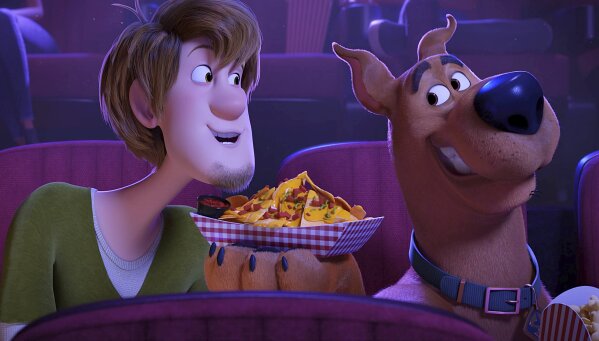 This image released by Warner Bros. Pictures shows characters Shaggy, voiced by Will Forte, left, and Scooby-Doo, voiced by Frank Welker, in a scene from the animated film "Scoob!" The Scooby-Doo film will bypass theaters and premiere directly on digital platforms, Warner Bros. said Tuesday, making it the latest studio to experiment with an on-demand release during the pandemic shutdown. (Warner Bros. Pictures via AP)
