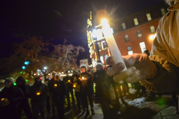 People gather in Pliny Park in Brattleboro, Vt., for a vigil, Monday, Nov. 27, 2023, for the three Palestinian-American students who were shot while walking near the University of Vermont campus in Burlington, Vt., Saturday, Nov. 25. The three students were being treated at the University of Vermont Medical Center, and one faces a long recovery because of a spinal injury, a family member said. (Kristopher Radder/The Brattleboro Reformer via AP)