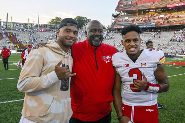 Maryland's head coach Mike Locksley, center, quarterback Taulia Tagovailoa, right, and his older brother Tua Tagovailoa celebrate a win against West Virginia in an NCAA college football game Saturday, Sept. 4, 2021 in College Park, Md. (Kevin Richardson/The Baltimore Sun via AP)
