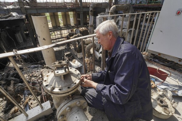 A worker repairs damaged thermal power plant, one of the country's largest, recently destroyed by Russian missiles near Kharkiv, Ukraine, Friday, April 12, 2024. (AP Photo/Andrii Marienko)