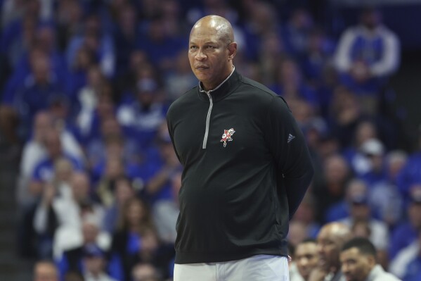 FILE - Louisville coach Kenny Payne watches the team during the second half of an NCAA college basketball game against Kentucky in Lexington, Ky.,Dec. 31, 2022. Arkansas has announced that Payne has been named associate head coach under new head coach John Calipari. Payne spent 10 years as an assistant for Calipari at Kentucky. (AP Photo/James Crisp, File)