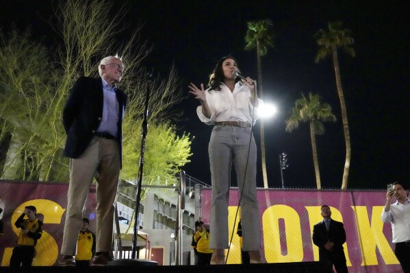 Sen. Bernie Sanders, I-Vt., and Rep. Alexandria Ocasio-Cortez, D-N.Y., speak outside of Arizona State University to the overflow crowd that did not get inside the arena, during a "Fighting Oligarchy" tour event Thursday, March 20, 2025, in Tempe, Ariz. (AP Photo/Ross D. Franklin)