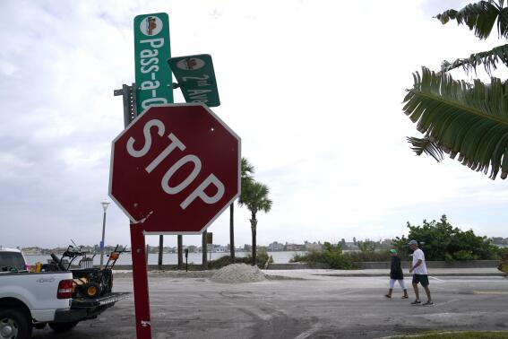 A street sign is damaged in the aftermath of Tropical Storm Eta, Thursday, Nov. 12, 2020, in the Passe-A-Grille neighborhood of St. Pete Beach, Fla. Eta dumped torrents of blustery rain on Florida's west coast as it slogged over the state before making landfall near Cedar Key, Fla. (AP Photo/Lynne Sladky)