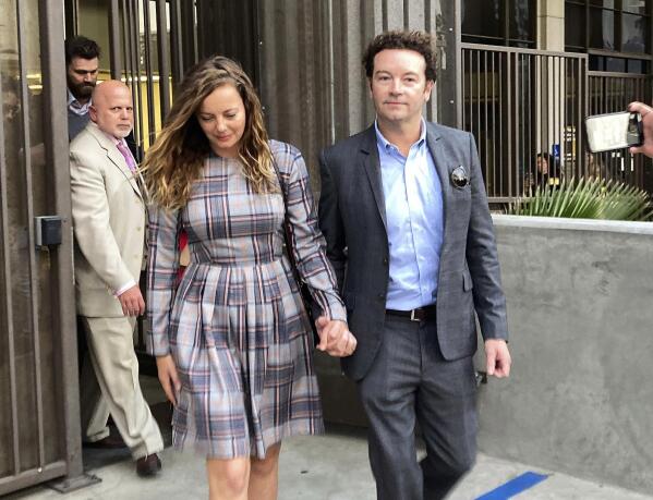 FILE - Actor Danny Masterson leaves Los Angeles superior Court with his wife Bijou Phillips after a judge declared a mistrial in his rape case in Los Angeles on Nov. 30, 2022. Masterson is going back on trial on three charges of rape. A deadlocked jury led to a mistrial for Masterson in November. Opening statements in his retrial will begin on Monday. (AP Photo/Brian Melley, File)