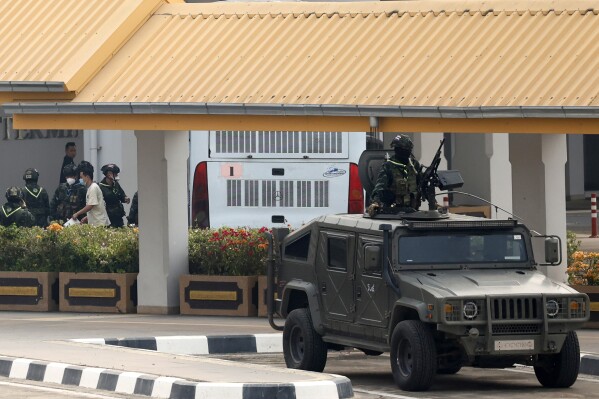 Thai soldiers provide security for the transfer of Chinese nationals who had worked at scam centers in eastern Myanmar, on their arrival at Thailand's Mae Sot International Airport, Tak province before being sent back to China on Thursday, Feb. 20, 2025. (AP Photo/Sarot Meksophawannakul, File)