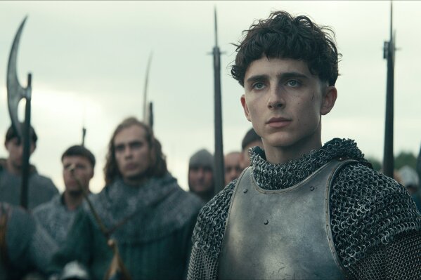 This image released by Netflix shows Timothée Chalamet, center, in a scene from "The King." (Netflix via AP)