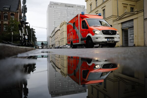 FILE-In this Sept.2, 2020 file photo a rescue vehicle drives in front of the central building of the Charite hospital where the Russian opposition leader Alexei Navalny is being treated, in Berlin, Germany. The German hospital treating Russian opposition leader Alexei Navalny for poisoning says his condition improved enough for him to be released from the facility. The Charite hospital in Berlin said Wednesday that after 32 days in care, Navalny’s condition “improved sufficiently for him to be discharged from acute inpatient care.” (AP Photo/Markus Schreiber)