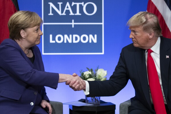 FILE 鈥� Then-U.S. President Donald Trump shakes hands with then-German Chancellor Angela Merkel during a NATO summit in Watford, England, Wednesday, Dec. 4, 2019. As chances rise of a Joe Biden-Trump rematch in the U.S. presidential election race, America鈥檚 allies are bracing for a bumpy ride, with concerns rising that the U.S. could grow less dependable regardless of who wins. (AP Photo/ Evan Vucci, File)