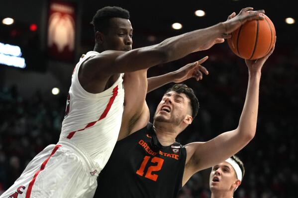 Arizona center Christian Koloko blocks the shot of Oregon State center Roman Silva (12) during the first half of an NCAA college basketball game Thursday, Feb. 17, 2022, in Tucson, Ariz. (AP Photo/Rick Scuteri)