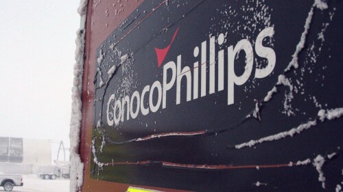 FILE - An ice-covered ConocoPhillips sign is displayed at the Colville-Delta 5, more commonly known as CD5, drilling site on Alaska's North Slope, Feb. 9, 2016. ConocoPhillips Alaska faces a potential $914,000 fine over what a state regulatory agency called a “shallow underground blowout” of a well that released natural gas at the company's Alpine field on Alaska's petroleum-rich North Slope in 2022. (AP Photo/Mark Thiessen, File)