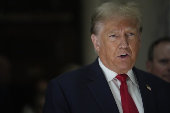 FILE - Former President Donald Trump, speaks to reporters as he leaves the courtroom during a lunch break in his civil business fraud trial, Oct. 4, 2023, in New York. Trump's lawyers have asked a judge to postpone his Florida classified documents trial until after next year’s presidential election. The lawyers say they have not received all the records they need to prepare Trump's defense. (AP Photo/Mary Altaffer, File)