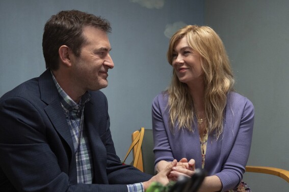 This image released by Disney shows Mark Duplass, left, and Ellen Pompeo in a scene from "Good American Family." (Ser Baffo/Disney via AP)