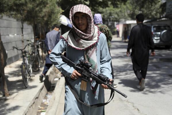 A Taliban fighter stands guard at a checkpoint in the Wazir Akbar Khan neighborhood in the city of Kabul, Afghanistan, Sunday, Aug. 22, 2021. A panicked crush of people trying to enter Kabul's international airport killed several Afghan civilians in the crowds, the British military said Sunday, showing the danger still posed to those trying to flee the Taliban's takeover of the country. (AP Photo/Rahmat Gul)