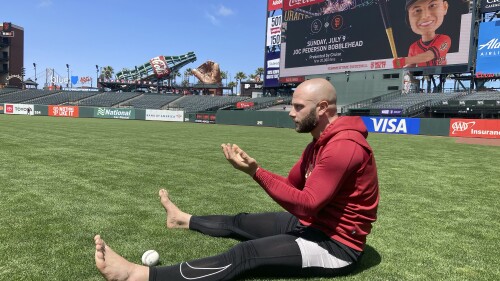 Arizona Diamondbacks' Christian Walker warms up barefoot on the field before a baseball game between the Diamondbacks and the San Francisco Giants in San Francisco, Friday, June 23, 2023. (AP Photo/Janie McCauley)