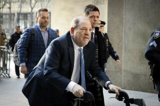 In this Feb. 24, 2020, file photo, Harvey Weinstein arrives at a Manhattan courthouse as jury deliberations continue in his rape trial in New York. A Delaware judge has approved a revised Weinstein Co. bankruptcy plan that provides about $35 million for creditors, with roughly half that amount going to women who've accused Weinstein of sexual misconduct. The judge approved the plan following a hearing and overruled objections by attorneys representing four women. (AP Photo/John Minchillo, File)