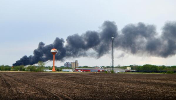 Smoke billows from a train derailment, Sunday, May 16, 2021, in Sibley, Iowa. Union Pacific spokeswoman Robynn Tysver said about 47 railcars came off the tracks during the derailment, but the train crew was not injured. (Mason Dockter/Sioux City Journal via AP)
