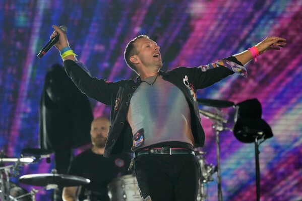 Chris Martin of Coldplay performs at the Rose Bowl, Saturday, Sept. 30, 2023, in Pasadena, Calif. (AP Photo/Chris Pizzello)