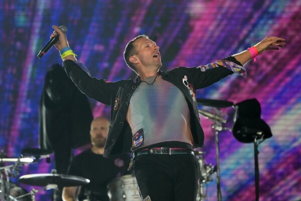 Chris Martin of Coldplay performs at the Rose Bowl, Saturday, Sept. 30, 2023, in Pasadena, Calif. (AP Photo/Chris Pizzello)