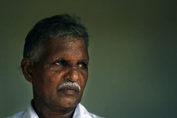 Subramaniam Paramanandam, a farmer, talks to Associated Press, in Thunukkai, Sri Lanka, Wednesday, May 8, 2024. Paramanandam recounts how he and a dozen others pleaded with clasped hands with U.N. officials and other international humanitarian groups not to leave Sri Lanka's northern battle zone. For more than 15 years, Paramanandam and many like him still search for justice for alleged war crimes and again look to the U.N. for a speedy solution. (AP Photo/Eranga Jayawardena)