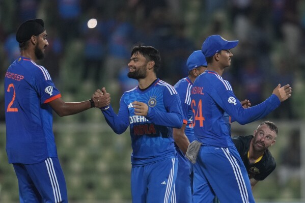 Australia's captain Matthew Wade, right, looks on as India players celebrate after Australia lost their second T20 cricket match against India in Thiruvananthapuram, India, Sunday, Nov. 26, 2023. (AP Photo/Aijaz Rahi)