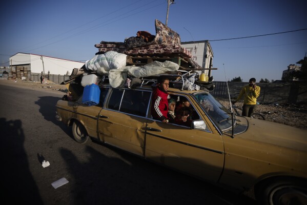 Palestinians flee an Israeli attack in Khan Yunis, Gaza Strip, on Wednesday, December 6, 2023.  (AP Photo/Mohammed Dahman)
