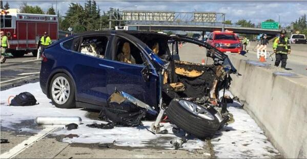 FILE - In this March 23, 2018, file photo provided by KTVU, emergency personnel work a the scene where a Tesla electric SUV crashed into a barrier on U.S. Highway 101 in Mountain View, Calif. The Apple engineer who died when his Tesla Model X crashed into the concrete barrier complained before his death that the SUV's Autopilot system would malfunction in the area where the crash happened. The driver of another Tesla involved in a fatal crash that California highway authorities said may have been on operating on Autopilot posted social media videos of himself riding in the vehicle without his hands on the wheel or foot on the pedal. The May 5, 2021, crash in Fontana, a city 50 miles (80 kilometers) east of Los Angeles, is also under investigation by the National Highway Traffic Safety Administration. The probe is the 29th case involving a Tesla that the federal agency has probed. (KTVU-TV via AP, File)