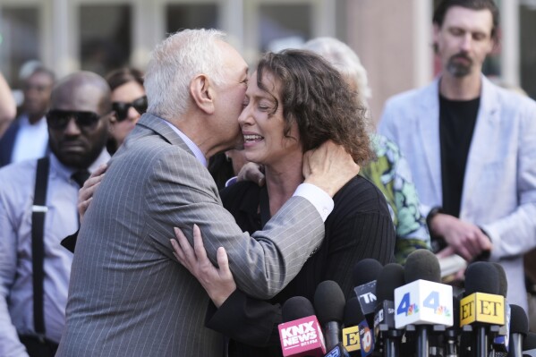 Attorney Mark Geragos, left, hugs Anamaria Baralt, cousin of Erik and Lyle Menendez, after the brothers' resentencing hearing Tuesday, May 13, 2025, in Los Angeles. (AP Photo/Damian Dovarganes)
