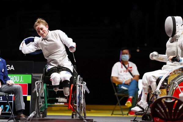 FILE - In this Saturday, Aug. 28, 2021 file photo, Italy's Beatrice Maria Vio, left, celebrates after winning over China's Zhou Jingjing during their the wheelchair fencing women's foil Individual category B gold medal match in Chiba, at the Tokyo 2020 Paralympic Games. (Kyodo News via AP, File)