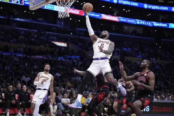 Los Angeles Lakers forward LeBron James (6) scores past Chicago Bulls forward Patrick Williams during the second half of an NBA basketball game, Sunday, March 26, 2023, in Los Angeles. (AP Photo/Marcio Jose Sanchez)