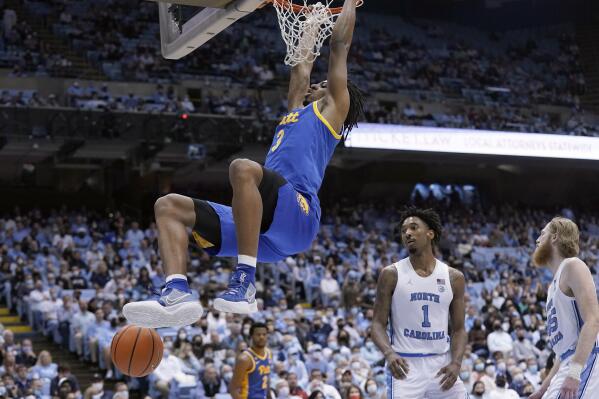 Pittsburgh forward Noah Collier (3) dunks against North Carolina during the second half of an NCAA college basketball game in Chapel Hill, N.C., Wednesday, Feb. 16, 2022. (AP Photo/Gerry Broome)