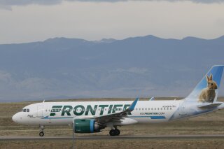 In this April 23, 2020 photo a Frontier Airlines jetliner taxis to a runway for take off from Denver International Airport in Denver. Lawmakers on Capitol Hill lashed out Wednesday, May 6, 2020 against Frontier Airlines over the budget carrier's move to charge passengers extra to guarantee they will sit next to an empty middle seat while flying during the coronavirus outbreak. (AP Photo/David Zalubowski)