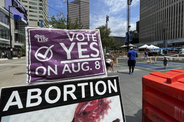 FILE - A sign asking Ohioans to vote in support of Issue 1 sits above another sign advocating against abortion rights at an event hosted by Created Equal on July 20, 2023, in Cincinnati, Ohio. Turnout is robust and misinformation rampant as Ohio concludes a hastily called and highly charged special election Tuesday, a contest that could determine the fate of abortion rights in the state and fuel political playbooks nationally heading into 2024. (AP Photo/Patrick Orsagos, File)