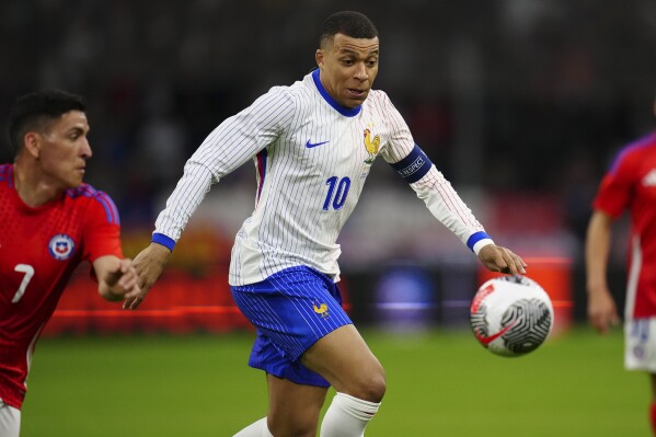 FILE - France's Kylian Mbappe goes for the ball during an international friendly soccer match between France and Chile at the Orange Velodrome stadium in Marseille, southern France, Tuesday, March 26, 2024. The 24-team lineup is complete and all roads now lead to Germany for the European Championship. (AP Photo/Daniel Cole, File)