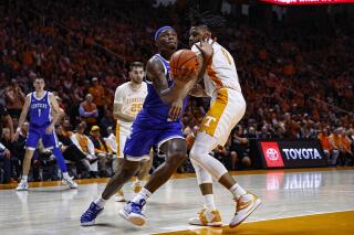 Kentucky forward Oscar Tshiebwe (34) drives against Tennessee forward Jonas Aidoo (0) during the second half of an NCAA college basketball game Saturday, Jan. 14, 2023, in Knoxville, Tenn. (AP Photo/Wade Payne)