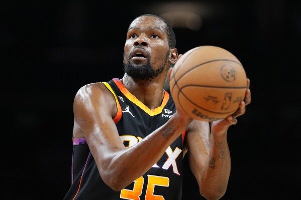 FILE - Phoenix Suns forward Kevin Durant plays against the Denver Nuggets during the first half of Game 4 of an NBA basketball Western Conference semifinal game, May 7, 2023, in Phoenix. The Suns — outside of three-time All-Star Devin Booker — are nearly unrecognizable just eight months after Mat Ishbia bought the team for roughly $4 billion from embattled owner Robert Sarver. (AP Photo/Matt York, File)