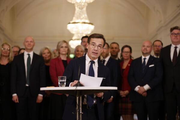 Swedish Prime Minister Ulf Kristersson holds a press meeting to present his cabinet ministers, in Stockholm, Tuesday, Oct. 18, 2022. Sweden's new head of government has presented his center-right coalition that has promised to crack down on crime and curtail immigration in partnership with a populist party with far-right roots. (Christine Olsson/TT News Agency via AP)