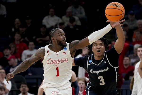 Houston guard Jamal Shead (1) grabs a loose ball away from Longwood guard DA Houston (3) during the first half of a first-round college basketball game in the NCAA Tournament, Friday, March 22, 2024, in Memphis, Tenn. (AP Photo/George Walker IV)