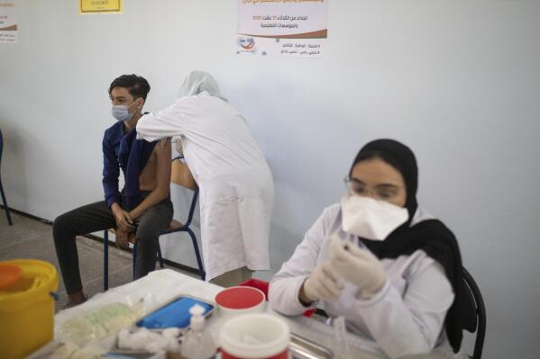 School students and their parents wait to receive their COVID-19 vaccines  as Morocco launches a campaign to vaccinate 12-17 year olds before the  start of the school year, in Rabat, Morocco, Tuesday