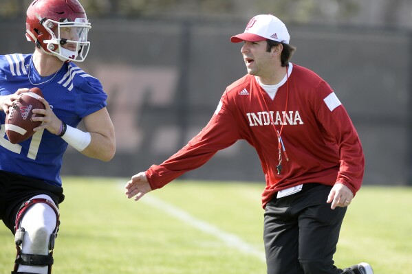 FILE - Indiana quarterbacks coach Nick Sheridan works with Richard Lagow (21) during NCAA college football practice in Bloomington, Ind., Sunday, March 5, 2017. Alabama head football coach Kalen DeBoer announced the hiring of Nick Sheridan and JaMarcus Shephard to lead the Crimson Tide's offensive staff on Tuesday, Feb. 20, 2024.(Chris Howell/The Herald-Times via AP, File)