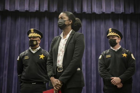 Cook County State's Attorney Kim Foxx stands in front of Chicago Police First Deputy Supt. Eric Carter, left, and CPD Chief of Operations Brian McDermott during a press conference at the Chicago Police Department headquarters in the Bronzeville neighborhood, Wednesday, Jan. 26, 2022, where officials announced charges against suspects in the fatal shooting of 8-year-old Melissa Ortega. (Pat Nabong/Chicago Sun-Times via AP)