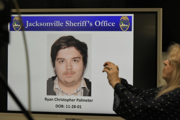 A photograph of shooter Ryan Christopher Palmeter is shown on a video monitor during Sheriff T.K. Waters' press conference at the Jacksonville Sheriff's Office headquarters building in Jacksonville, Fla., Sunday, Aug, 27, 20123. (Bob Self/The Florida Times-Union via AP)