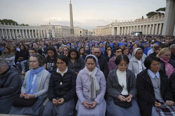 Faithful participate in a rosary prayer for the late Pope Francis, in St. Peter's Square at the Vatican, Monday April 21, 2025. (AP Photo/Alessandra Tarantino)