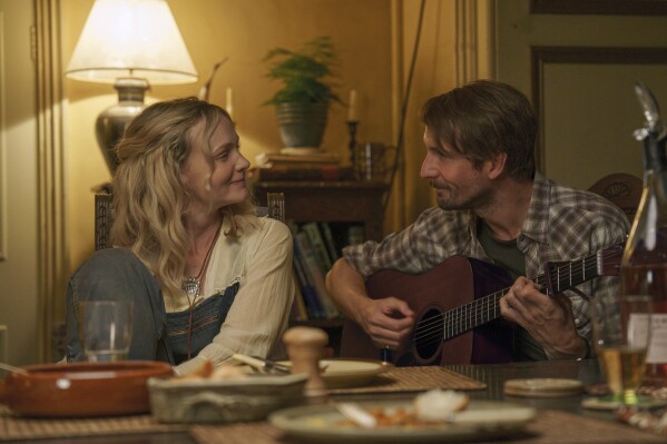 This image released by Focus Features shows Carey Mulligan, left, and Tom Basden in a scene from "The Ballad of Wallis Island." (Focus Features via AP)