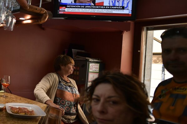 
              Customers stand in a bar while the television broadcasts the news of the arrest of Basque separatist militant Josu Ternera in his home town of Ugao-Miraballes, Spain, Thursday, May 16, 2019. The most wanted member of the Basque separatist militant group ETA who had been on the run for 17 years was finally caught by police on Thursday May 16, 2019 in the French Alps. Jose Antonio Urruticoetxea Bengoetxea, known by the alias Josu Ternera, was a longtime chief of ETA and connected to some of its bloodiest episodes. (AP Photo/Alvaro Barrientos)
            