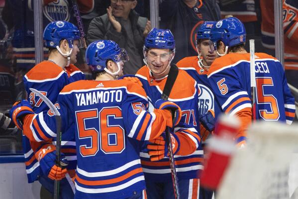 Edmonton Oilers' Ryan McLeod (71) celebrates with teammates after his goal against the Calgary Flames during the second period of an NHL hockey game Saturday, Oct. 15, 2022, in Edmonton, Alberta. (Jason Franson/The Canadian Press via AP)